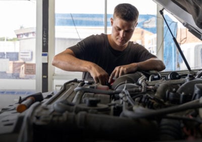 Diesel mechanic performing vehicle servicing