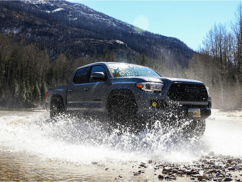 High-performance diesel tuning Sunshine Coast: A Toyota 4WD splashing through a river crossing, demonstrating the increased power and off-road capability of custom ECU remapping.